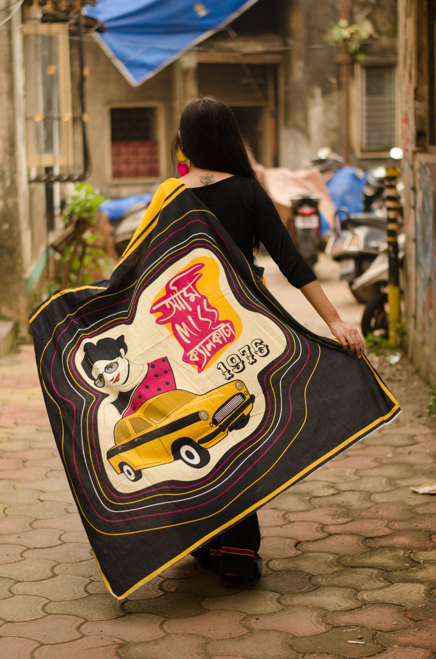 Close-up of digital print featuring Aparna Sen and yellow ambassador cab